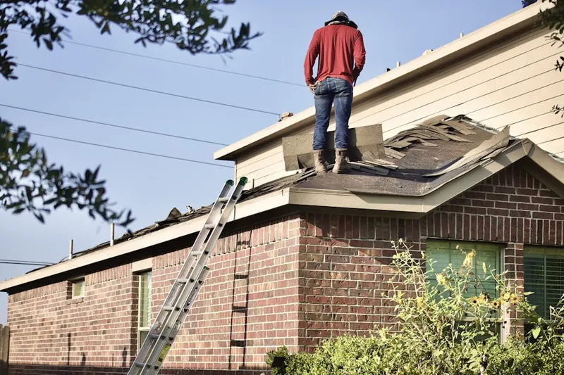 Professional roofer working on a residential roof in Douglas